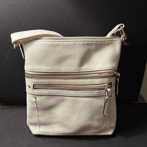 Beautiful off white cross body with outside zippers and several sections